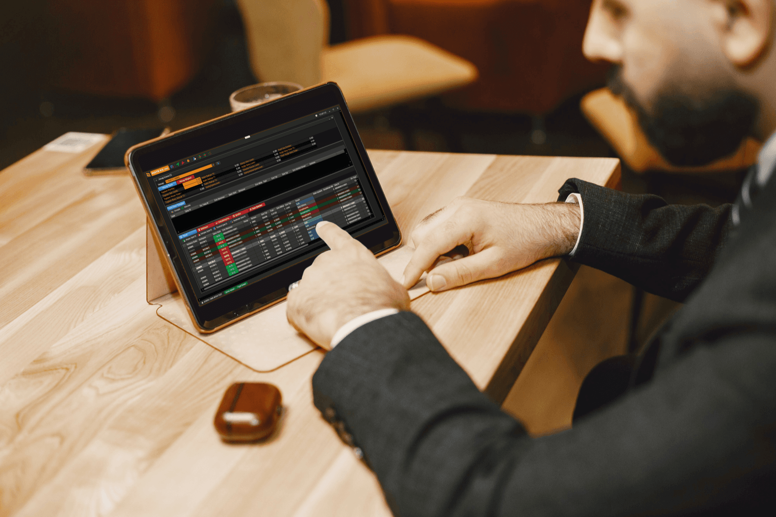 A portfolio manager using OMS Neo on a tablet between meetings